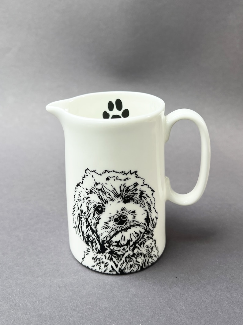 The front of the half pint jug with a very cute Cockapoo and a paw print on the inside.