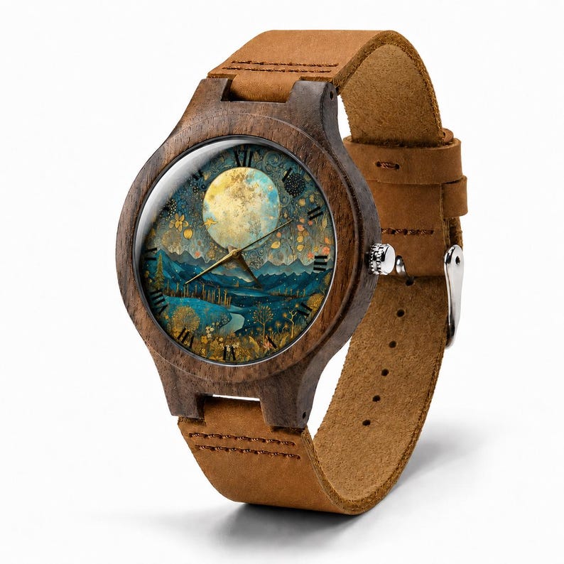 May include: A wristwatch with a dark brown wooden case and a tan leather strap. The watch face features a circular illustration of a full moon over a blue landscape with golden trees and Roman numeral hour markers. A silver crown is on the side.