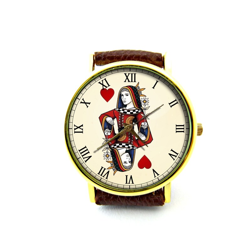 May include: A gold-tone wristwatch with a brown leather band. The watch face features a white background with Roman numeral hour markers and a playing card image of the Queen of Hearts.