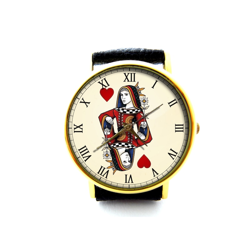 May include: A gold-tone wristwatch with a black leather band. The watch face features a white background with Roman numeral hour markers and a Queen of Hearts playing card design.