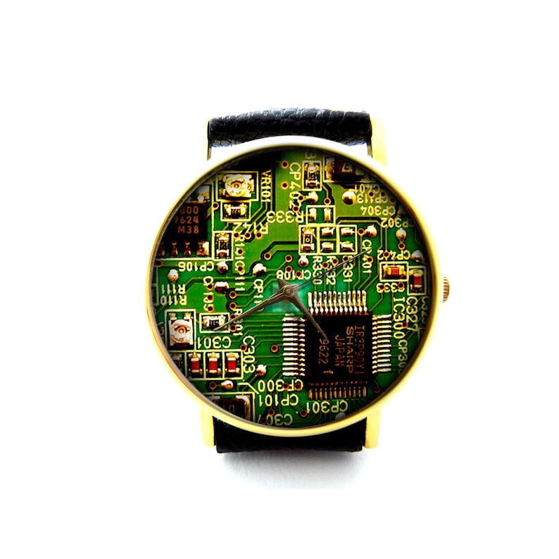 May include: A gold-tone wristwatch with a black leather band. The watch face features a green circuit board design with a silver-tone hour and minute hand.