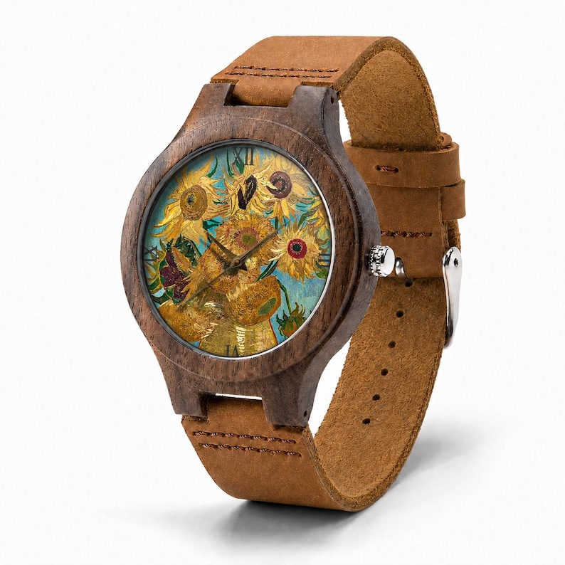 May include: A wooden wristwatch with a brown leather strap. The watch face features a painting of sunflowers in yellow, orange, and green against a blue background. The watch has a dark brown wooden case and a silver-colored buckle.