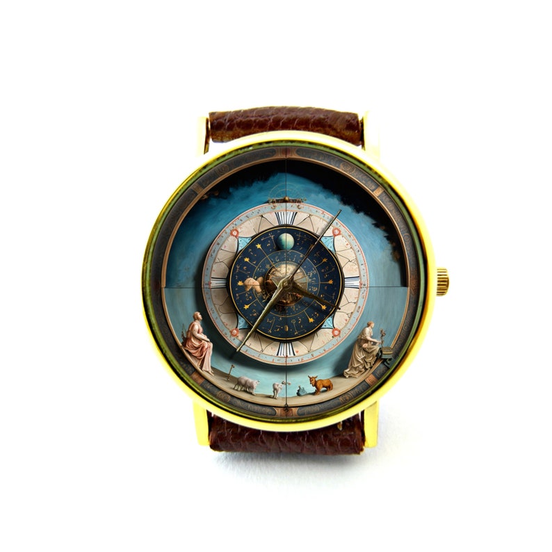 May include: A gold-tone wristwatch with a brown leather band. The watch face features a detailed illustration of a celestial sphere with zodiac symbols and planets.