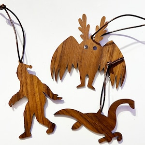 CRYPTMAS Ornaments - Walnut Hardwood Carved Holiday Ornaments - Cryptids - Bigfoot, MothMan,&  Loch Ness Monster