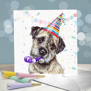 Toot Toot - A Border Terrier wearing a cone hat, holding a party blower