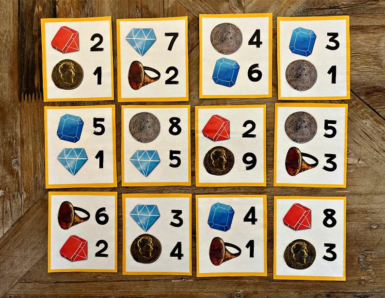 May include: Nine yellow cards with numbers and images. Each card has a different combination of a red gem, a blue gem, a coin, a ring, and a number. The numbers range from 1 to 9.