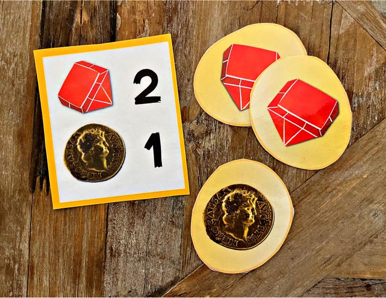 May include: A yellow card with the numbers 2 and 1 printed on it. There are two red gems and two gold coins on the card. The gems and coins are also on separate yellow circles.