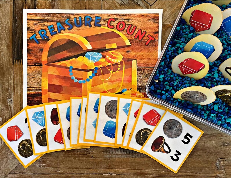 May include: A colorful educational game for kids featuring a treasure chest with gems and coins. The game includes cards with pictures of gems, coins, and numbers. The game is called "Treasure Count".