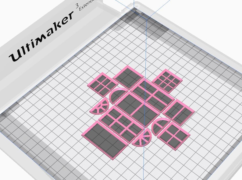 May include: A 3D-printed design featuring various window shapes in pink and grey, arranged on a grid. The word "Ultimaker" is visible in the upper left corner. The design includes rectangular, square, and arched window shapes.