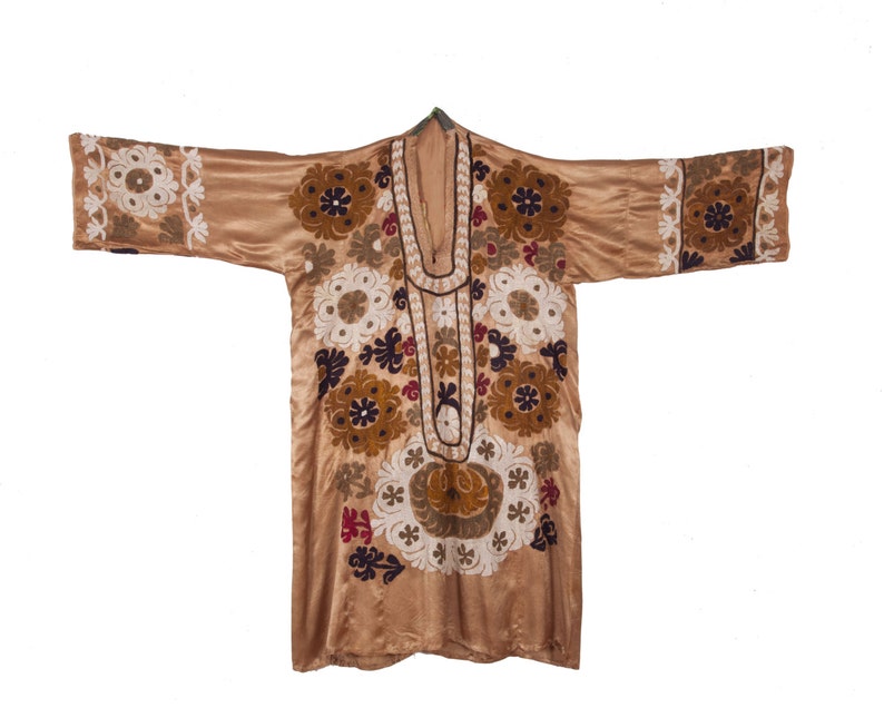 May include: A long-sleeved, beige silk robe with intricate embroidery in shades of brown, green, white, red, and blue. The embroidery features floral motifs.