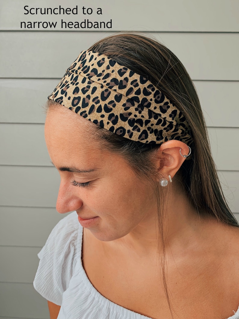 May include: A tan and black leopard print headband, scrunched to a narrow band, is worn on the head. The text "Scrunched to a narrow headband" is visible in the image.