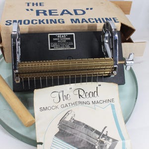 May include: A white ceramic mug with a black handle and the text "But First, Coffee" in a bold, black font. The mug is set against a blurred background, suggesting a cozy setting. The mug appears to be approximately 4 inches tall.