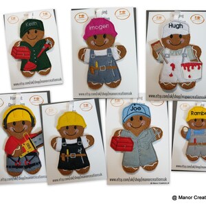 May include: Eight gingerbread people ornaments, each dressed as a different construction worker. The ornaments are decorated with felt and embroidery. The names Keith, Imogen, Hugh, Joe, Rambo are embroidered on the ornaments.