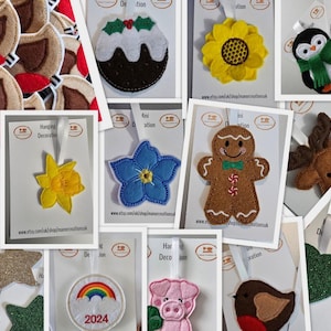 May include: Assortment of felt Christmas ornaments, including a gingerbread man, a reindeer, a robin, a sunflower, a bee, a forget-me-not flower, a Christmas pudding, a penguin, a rainbow, a pig, and a daffodil. The ornaments are all handmade and feature intricate details.
