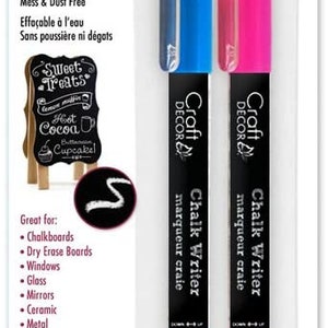 May include: Two-pack of Craft Decor chalk writers. One marker is blue, the other is pink. The markers are wet-erasable and mess-free. The packaging also shows a small chalkboard sign with the words "Sweet Treats".