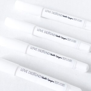 May include: Four white chalk crayons with black labels that read "LOVE DESIGNS Chalk Crayon NON-TOXIC - WET ERASE MADE IN KOREA".