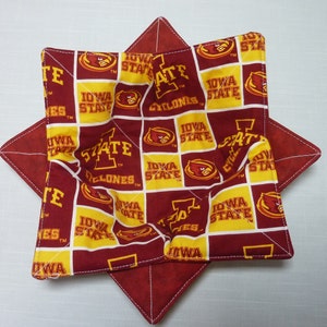 May include: A red and gold fabric bowl with a star shape. The fabric has a repeating pattern of the Iowa State Cyclones logo and the words "Iowa State".