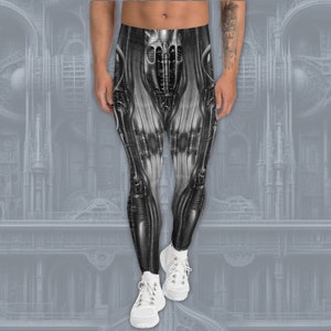 Może przedstawiać: Czarno-białe legginsy z nadrukiem graficznym przedstawiającym postać robota. Legginsy wykonane są z elastycznego, wygodnego materiału i mają dopasowany krój.