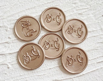 May include: Seven gold wax seals with the initials "B + C" embossed in a cursive font.