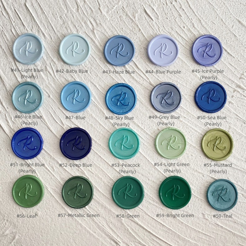 May include: A collection of twenty wax seals in various colors, including light blue, baby blue, and green. Each seal is round with a cursive "R" design. The colors are labeled with numbers and names, such as "#41-Light Blue" and "#50-Teal".