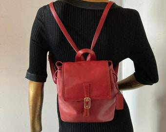 coach backpack purse red Refined pebble leather Zip closure fabric lining Outside zip pocket Attached split key ring and dogleash clip 3 1/4 (L) x 4 (H) x 1 1/2 (W) Style No. Vintage Coach Red Mini Daypack