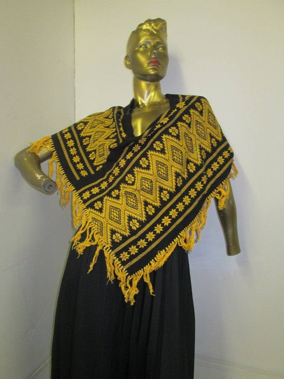 vintage 70s Guatemalan fringed poncho in a vibrant