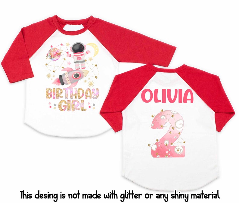 May include: A white and red raglan-style birthday shirt with a space theme. The front features an astronaut, rocket, and the words "BIRTHDAY GIRL." The back displays the name "OLIVIA" and the number "2."