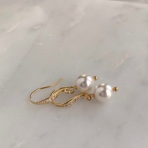 White pearl drop earrings with gold ear wires