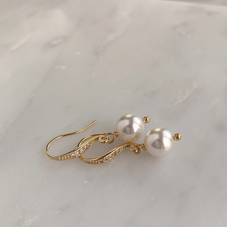 White pearl drop earrings with gold ear wires