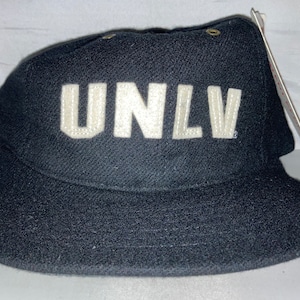 May include: A black UNLV baseball cap with a white embroidered logo.