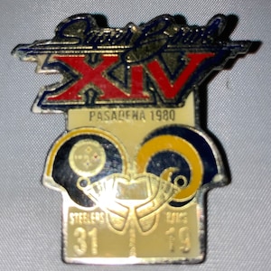May include: A gold Super Bowl XIV commemorative pin with the text "Super Bowl XIV" and "PASADENA 1980". The pin features two helmets, one black and one gold, with the scores "Steelers 31" and "Rams 19" underneath.