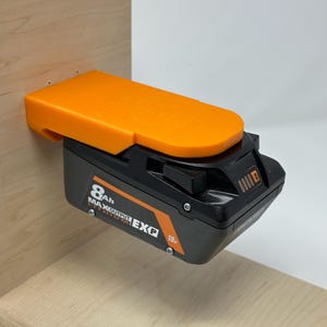 Wall mount battery holder compatible with Ridgid 18V batteries, 3D-printed organizer for workshop or garage. Durable 3D-printed wall mount for Ridgid 18V power tool batteries, easy-install storage bracket. Ridgid 18V battery wall holder and organizer, heavy-duty plastic mount for secure tool battery storage. Compact Orange wall-mounted rack designed to hold Ridgid 18V lithium power tool batteries. Space-saving Ridgid 18Vbattery mount for workshop walls, keeps batteries organized.