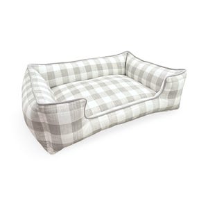 May include: A gray and white checkered dog bed with a gray border. The bed has a raised edge and a soft, comfortable cushion.