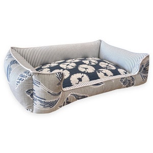 Beach nautical blue and grey pet bed on a white background.