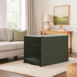 May include: A rectangular black metal wire pet crate covered by a dark green fabric cover featuring a white grid pattern. The cover fits snugly over the top and sides of the crate, which has a front door panel and a visible interior floor mat.