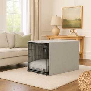 May include: A rectangular black wire pet crate featuring a light gray fabric cover that drapes over the top and sides. Inside the crate, a matching light gray rectangular cushion is placed on the floor, providing a soft surface for a pet.