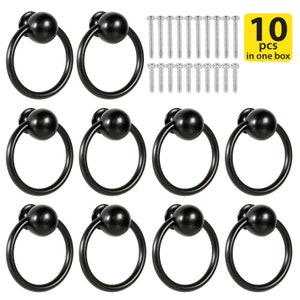 May include: Ten black ring cabinet pulls with a round knob. The pulls come with screws for installation.
