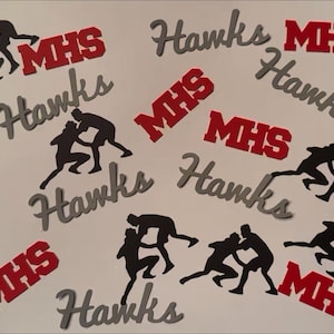 May include: A white background with scattered elements. Silhouettes of wrestlers in action are interspersed with the words "Hawks" in gray script and "MHS" in red block letters. The image has a sports theme.