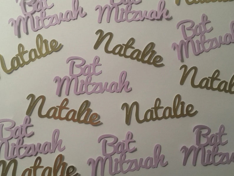 May include: Purple and gold paper cutouts with the text "Bat Mitzvah" and "Natalie".