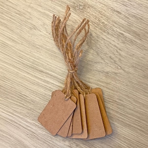 Etiquetas colgantes rectangulares de papel kraft marrón: etiquetas de precio en blanco con cordel.