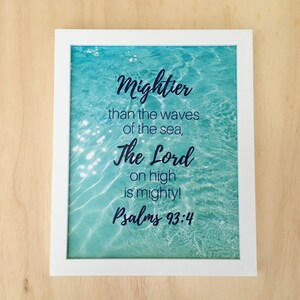 May include: White framed print with a blue water background and the text "Mightier than the waves of the sea, The Lord on high is mighty! Psalms 93:4"