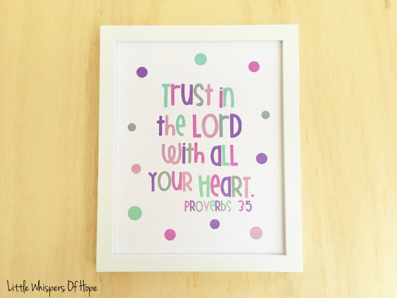 May include: A white framed print with a white background and colorful polka dots. The print features the text "Trust in the Lord with all your heart. Proverbs 35".