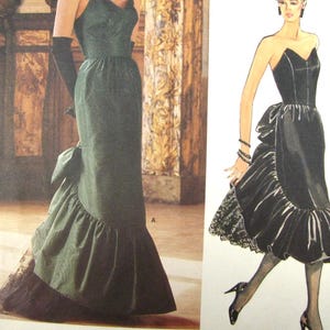 May include: An image of a vintage dress pattern. The pattern features a long, dark green gown with a ruffled hem and a bow detail. The illustration on the right shows a strapless black dress with a similar ruffled design.