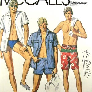May include: A vintage McCall's sewing pattern illustration featuring three figures. One wears a white short-sleeved shirt and blue swim trunks. Another wears a blue button-down shirt and matching shorts. The third wears red floral swim trunks.