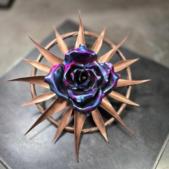 Hand-fabricated spinning copper compass rose that doubles as a 7th anniversary gift — the kind of one-of-a-kind kinetic metal piece you'd frame a story around.