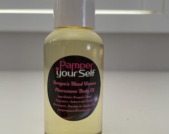 May include: A clear glass bottle with a white cap, filled with a yellow liquid. The bottle has a black label with the text "Pamper your Self" and "Dragon's Blood Women Pheromone Body Oil". The label also lists ingredients.