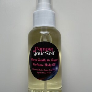 May include: A clear glass perfume body oil bottle with a white spray nozzle. The label reads "Pamper your Self" and "Warm Vanilla & Sugar Perfume Body Oil". The bottle contains 2 fl oz of oil.