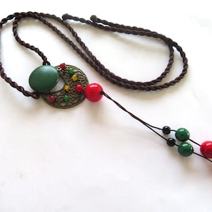 Pendant-Long Necklace vintage-filigree bronze frame-twisted 32 ins brown silken thread--jumper length-red, green and black beads