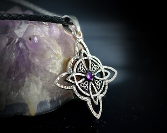May include: Silver Celtic knot pendant with a purple amethyst gemstone in the center. The pendant is on a black leather cord.