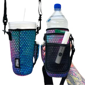 May include: A black and blue neoprene water bottle holder with a mermaid scale pattern. The holder has a mesh pocket and a strap for carrying. The holder is shown with a water bottle and a small tube of sunscreen.
